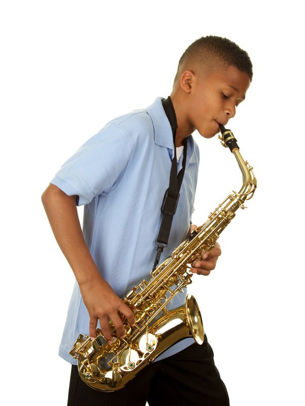Boy_with_saxophone_20-min Boy playing the saxophone after learning to play from online free music lessons